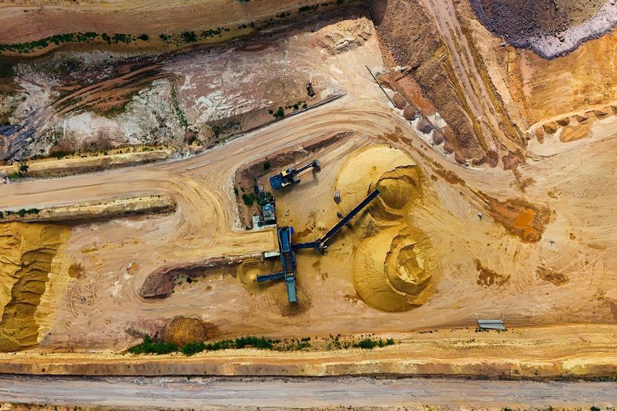 Aerial view of a quarry with stockpiles and screening plant